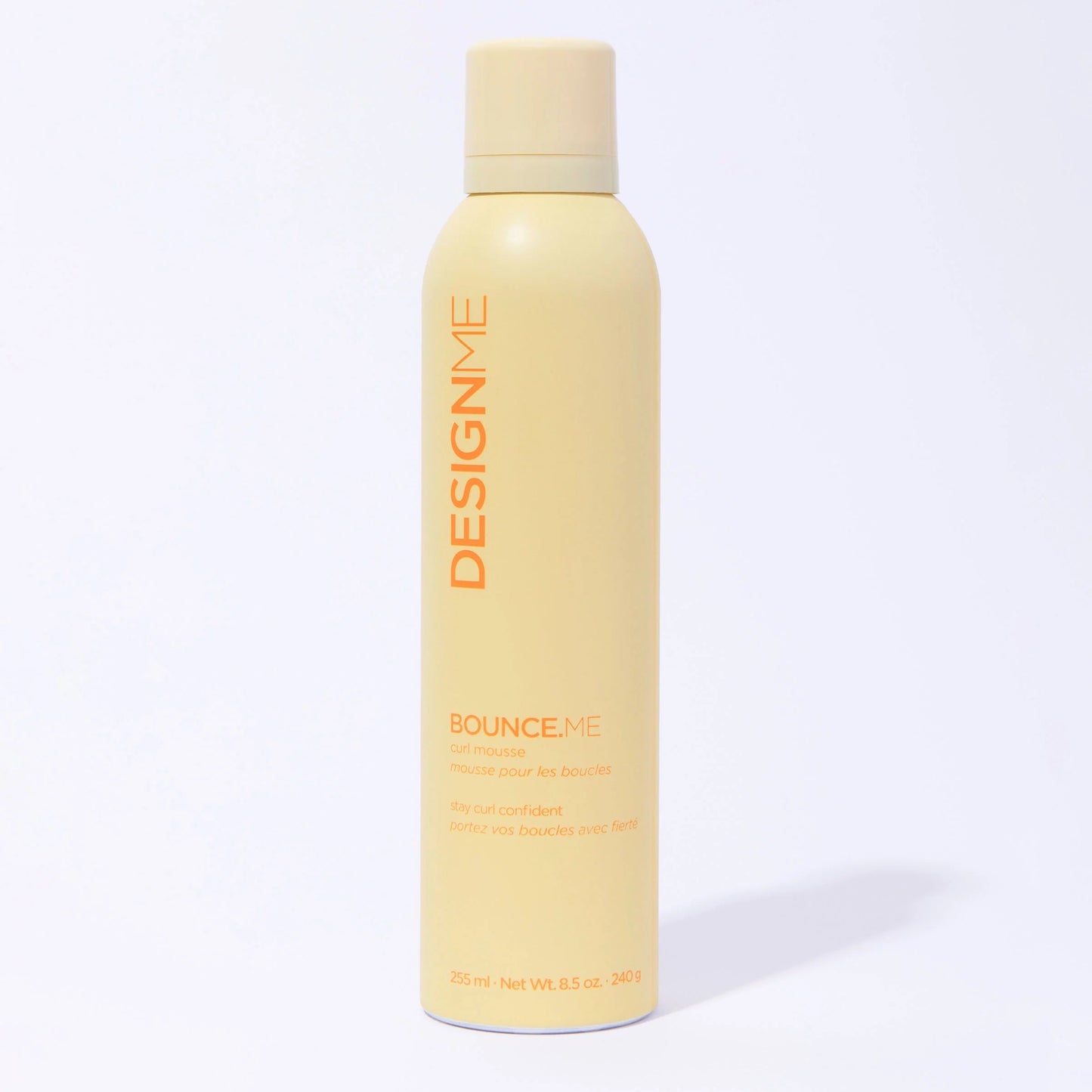 Yellow bottle of DESIGNME product on a white background