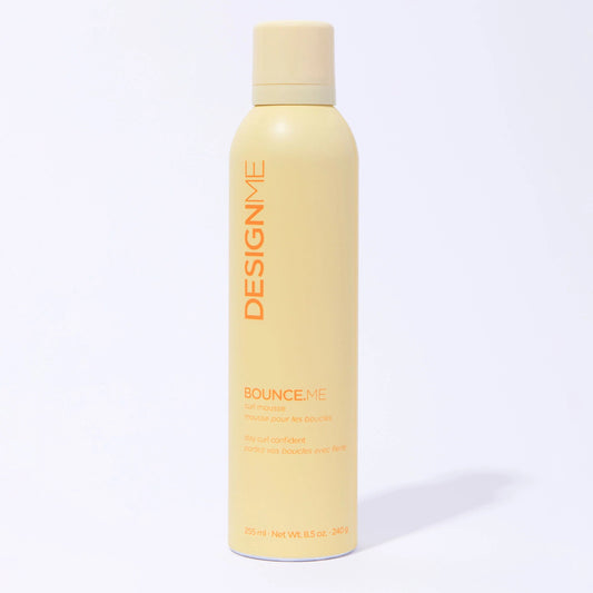 Yellow bottle of DESIGNME product on a white background